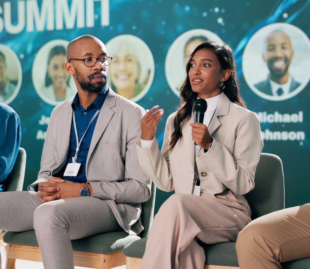 Seminar, presentation and group of business people on stage for coaching expert, event and convention in auditorium. Leadership, summit and speaker panel for networking workshop, tradeshow or speech
